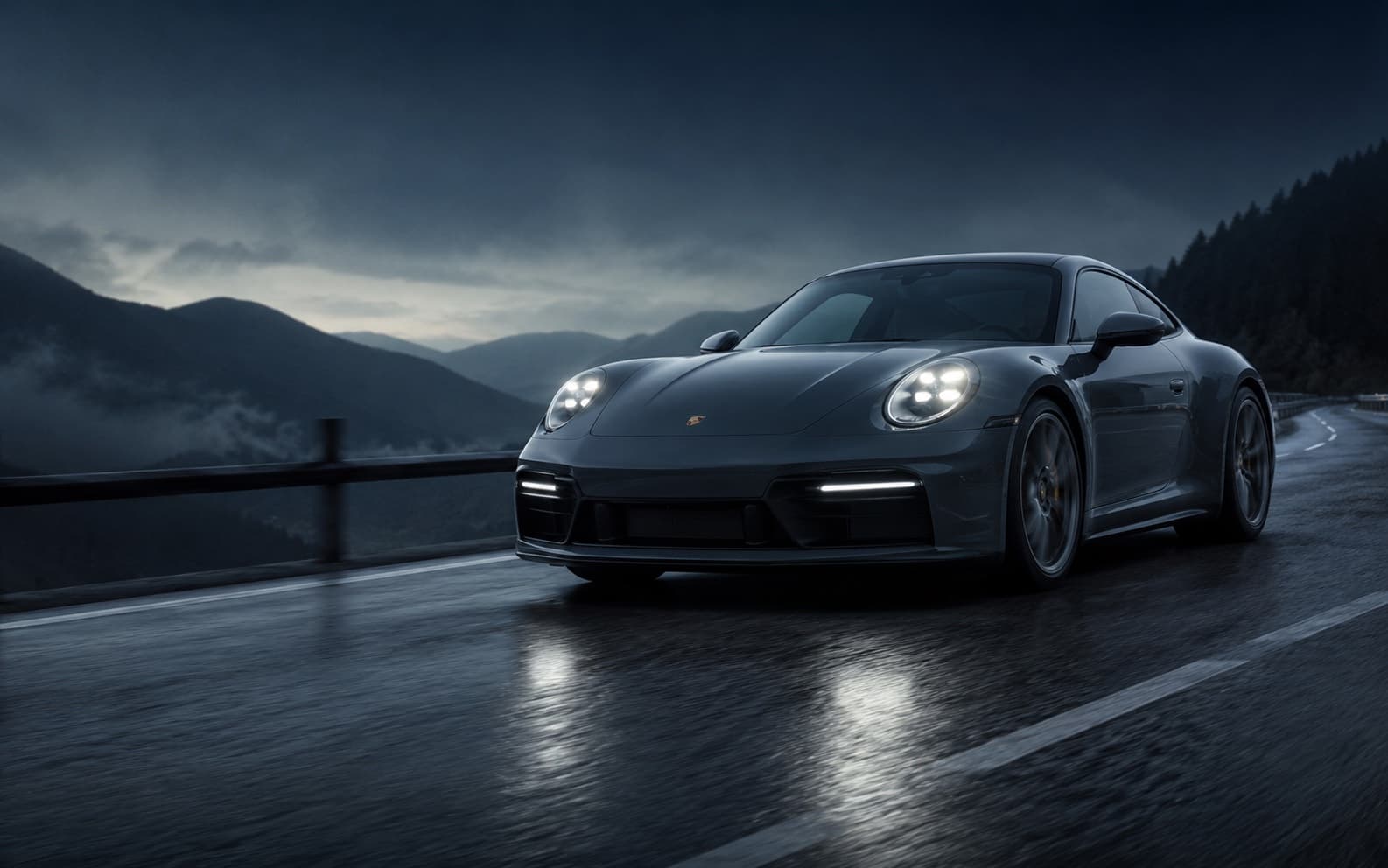 2026 Porsche 911 Carrera at blue hour on a wet mountain road, headlights on